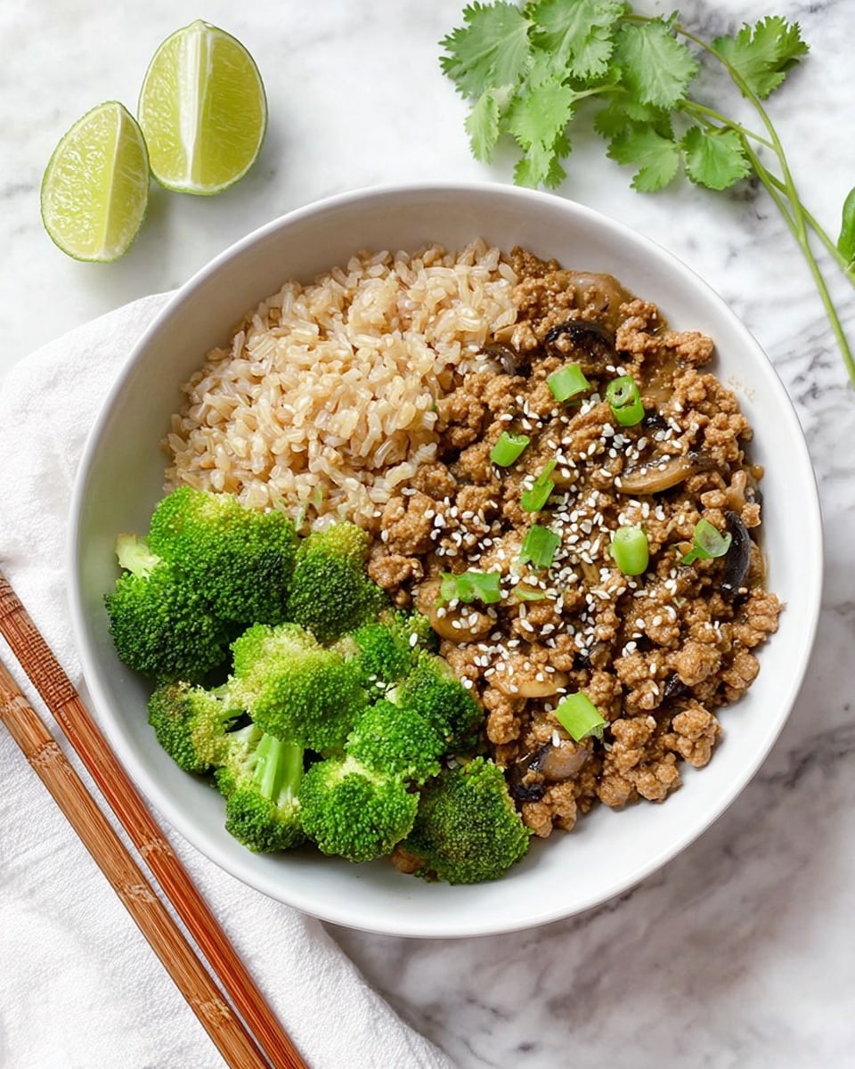 In a white bowl on a white marbled surface, there are three layers of food clearly visible. The first layer on the left is cooked brown rice, showing individual grains with a light tan color and a slightly fluffy texture. Next to it, on the right side, is a serving of ground meat cooked in a savory sauce, with a glossy brown color mixed with small sesame seeds and bits of green herbs scattered on top. At the top of the bowl, bright green steamed broccoli florets with a fresh and slightly crunchy texture complete the dish. Photo taken with an iphone --ar 4:5 --v 7