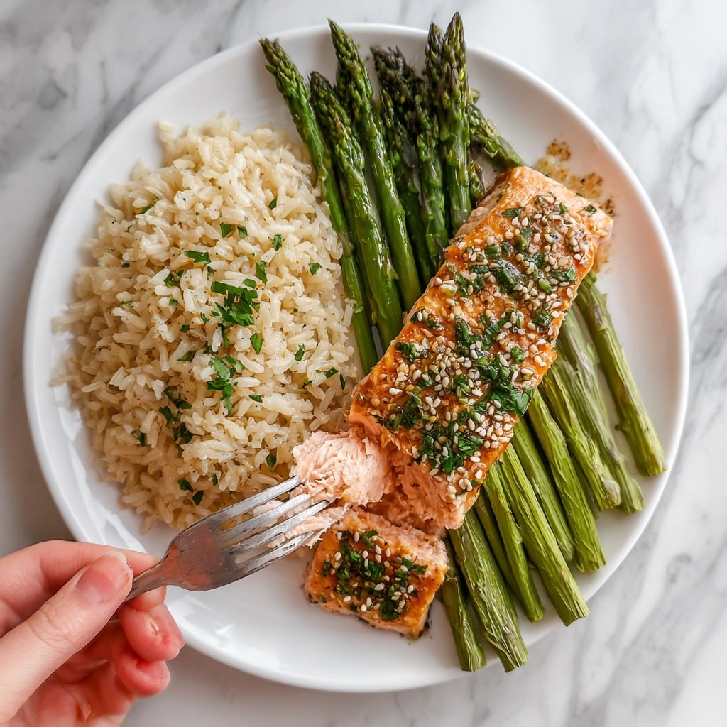 The image shows a plate with three food parts placed side by side on a white plate. On the left, there is a light beige portion of cooked rice with a soft texture. In the middle, there are long, thin green asparagus spears, slightly glistening and fresh-looking. On the right, a thick piece of cooked salmon with a light pink inside and a golden brown outside is topped with sesame seeds and green herbs. A woman's hand holds a fork that is cutting into the salmon piece, revealing its tender inside. The plate rests on a white marbled surface. Photo taken with an iphone --ar 4:5 --v 7