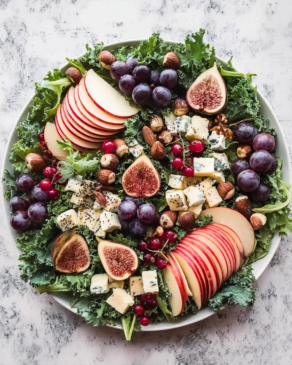 A white round plate filled with a fresh salad arranged in layers, starting with a base of large curly green kale leaves covering the plate. On top of the kale, there are thin half-circle slices of red apple neatly stacked in small groups, scattered around the plate. Next, halved figs with a pink and white inside and dark outer skin are spread across the salad. Small clusters of bright red currants with their stems are placed evenly, adding vibrant color. There are many dark purple grapes placed whole around the plate. Pieces of creamy blue cheese and soft white cheese chunks are dotted evenly, adding texture. Finally, whole hazelnuts scattered all over the salad and fine black seeds sprinkled lightly on the fruit slices finish the look. The whole plate is set on a white marbled textured surface. Photo taken with an iphone --ar 4:5 --v 7