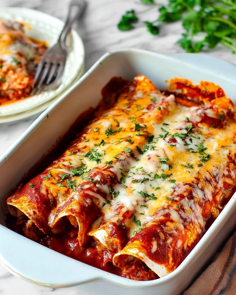 A white rectangular baking dish holds three rolled tortillas covered in red sauce and melted cheese, with the cheese browned slightly on top, and sprinkled with chopped green herbs. The tortillas look soft with some crispy edges showing. In the background, part of a white plate with a portion of the dish and a silver fork is visible, placed on a white marbled surface with a sprig of green herbs nearby. photo taken with an iphone --ar 4:5 --v 7