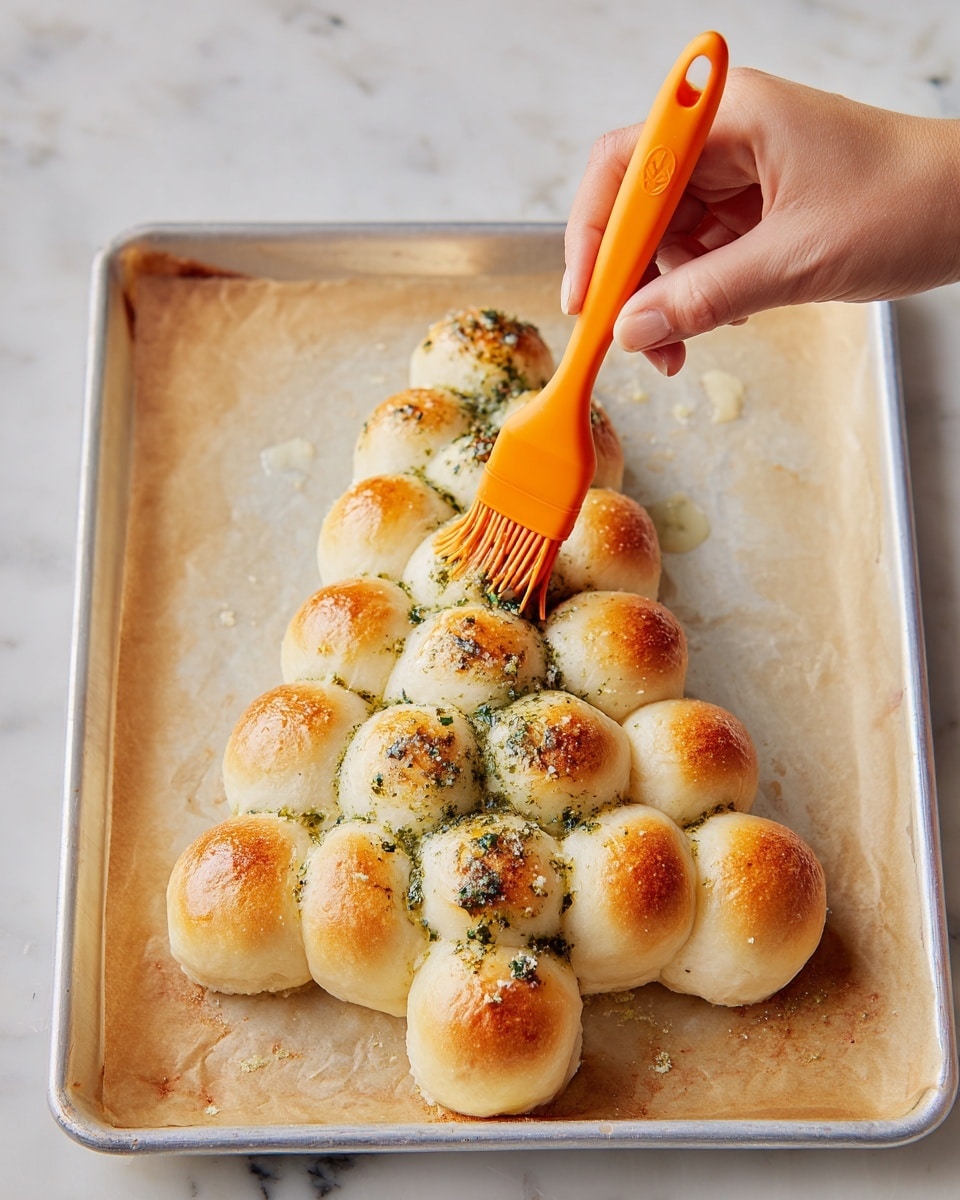This image shows a golden brown bread shaped like a Christmas tree made of 6 layers of round dough balls arranged symmetrically wider at the bottom and narrow at the top. The bread is sprinkled with white grated cheese and green chopped herbs, with some red chili flakes on top. A woman's hand is pulling one dough ball from the left side, stretching melted white cheese inside. To the right, a round white bowl of red tomato dipping sauce sits, with a smaller torn dough ball dipped in sauce beside it. The whole arrangement is on a white marbled surface. photo taken with an iphone --ar 4:5 --v 7