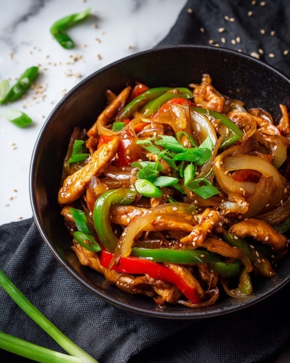 A black wok filled with a colorful stir-fry consisting of several layers: the base layer is light brown cooked sliced chicken, mixed with thinly sliced white onions, bright green bell pepper strips, and red bell pepper strips all cooked together in a glossy sauce. The dish is topped with small pieces of chopped green onions, adding a fresh green pop. A black metal spatula rests inside the wok, with a white marbled textured surface beneath and a gray cloth next to it. photo taken with an iphone --ar 4:5 --v 7
